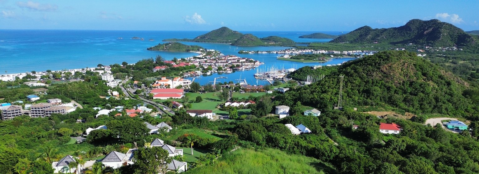 Sugar Ridge and Jolly Harbour marina from above, with the Caribbean Sea beyond