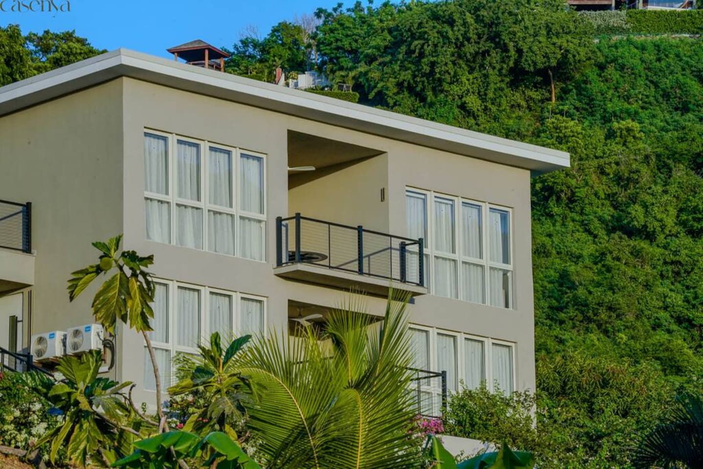Sugar Ridge Antigua luxury condo exterior — modern hillside residences above Jolly Harbour