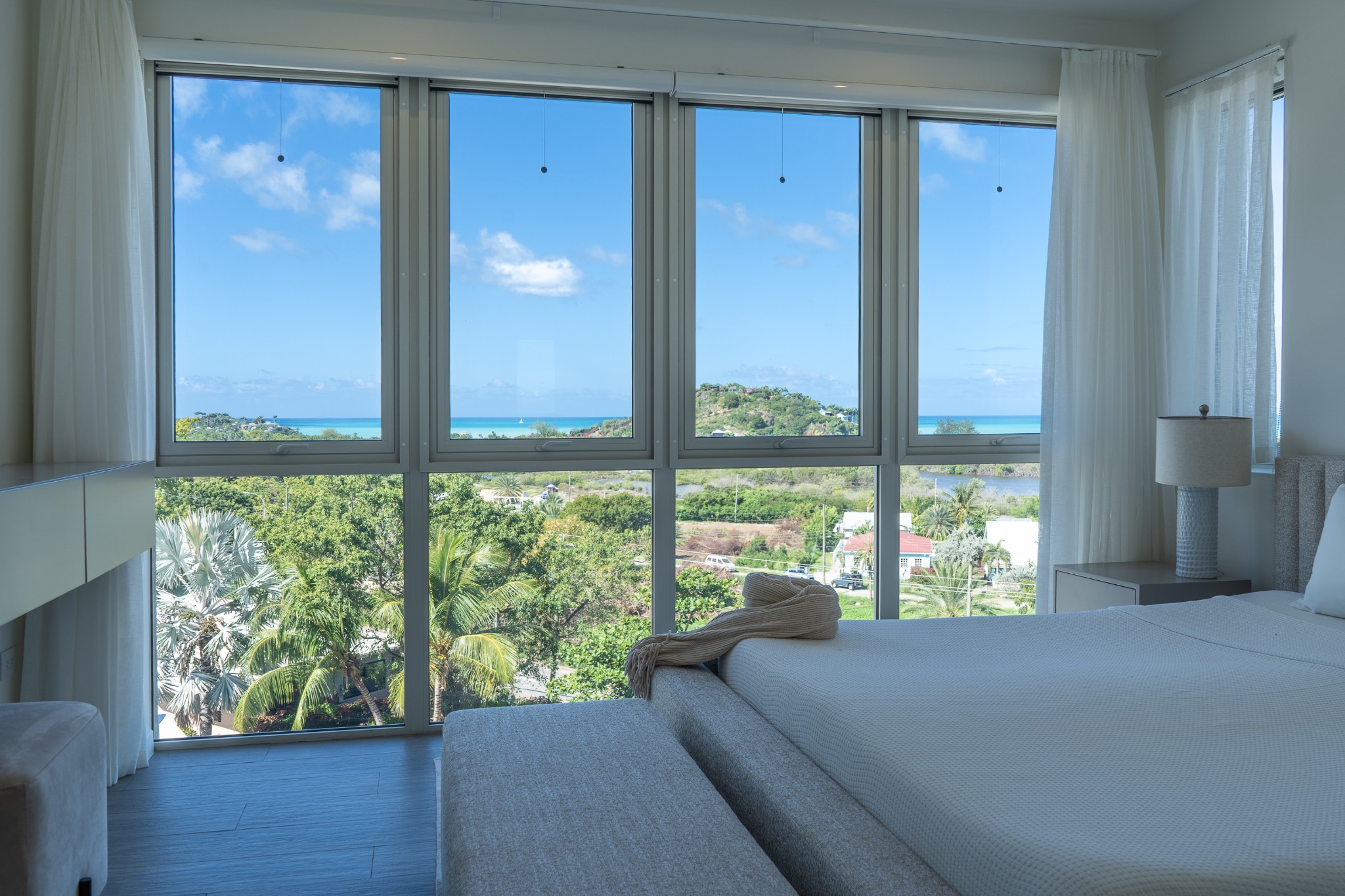 Master bedroom with panoramic Caribbean sea view at Sugar Ridge — available for standalone or co-ownership purchase