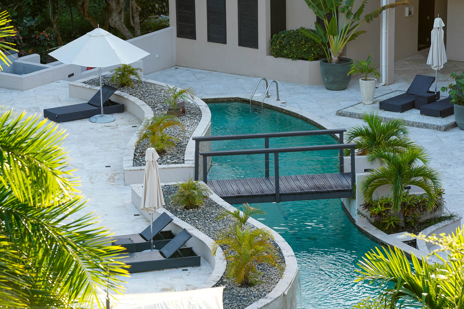 Resort-style pool at Sugar Ridge Condos with tropical landscaping and loungers