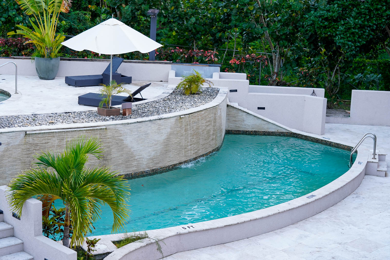 Cascading waterfall feature flowing into the resort pool at Sugar Ridge Antigua